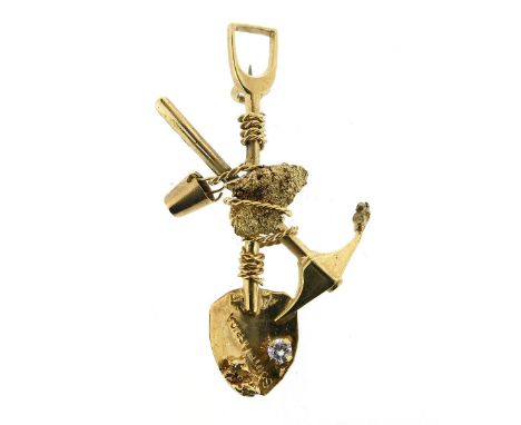 A gold miner's brooch, designed as a crossed pick-axe and shovel, centred with a gold nugget, suspending a bucket and spade m