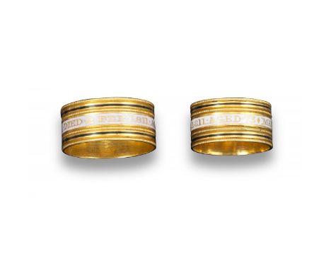 A pair of George III gold mourning rings, both 18ct yellow gold rings centred with a white enamel band within black enamel bo