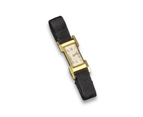 CARTIER - a lady's gold wristwatch, the rectangular cream dial signed Cartier with Roman numerals, the gold case numbered 639