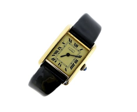 CARTIER - a silver-gilt Must de Cartier Tank wristwatch, signed yellow enamel dial with black Roman numerals, manual winding,