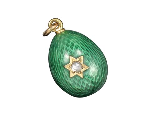 A green enamel egg pendant by Fabergй, workmaster August Hollming, decorated overall with green guilloche enamel and a six-po