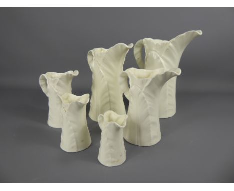 A Set of Six Cream Royal Worcester Graduated Jugs, of leaf design.