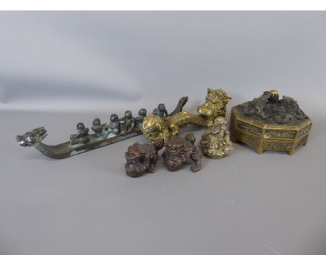 A Chinese Brass Scroll Weight, approx 21 cms together with a dragon boat with figures, approx 34 cms, two small bronzed Dogs 