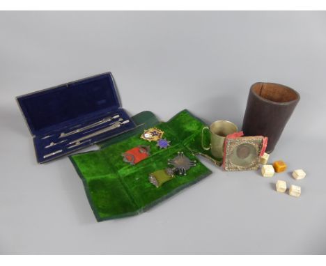 A Gentleman's Lot, including a hand stitched leather dice throw with antique dice, enamel and pewter beaker, drawing instrume