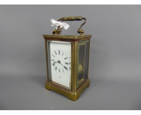 A French Brass Cased Carriage Clock, white enamel face with Roman dial stamped Byrne Paris, approx 15 x 6.5 cms, complete wit