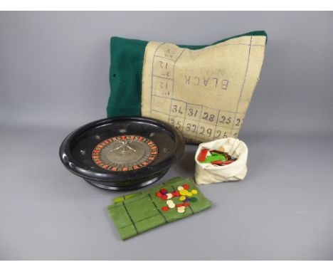 A Vintage Table-Top Roulette Wheel, together with a bag of coloured bone counters and baize together with an antique The New 