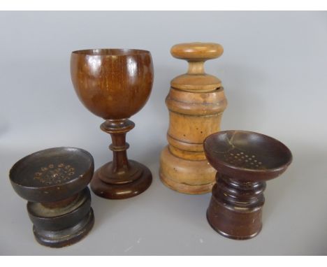 Four Treen items, including a pair of pounce pots, spice grinder and oak goblet.