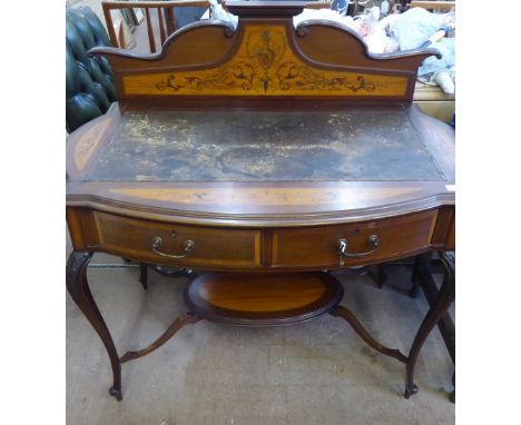 An Edwardian Desk, with a decoratively inlaid mantle and brown leather top above two drawers, on splayed legs joined by a cen