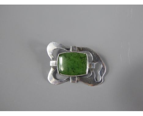 An Arts and Crafts Silver and Translucent Spinach Jade Brooch, the jade measuring approx 22 x 17 mm, approx 8 gms.