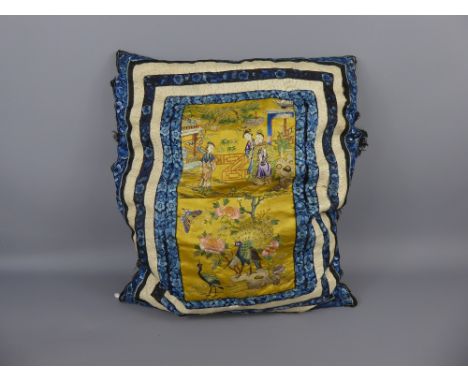 A Chinese Silk Embroidery Cushion, depicting figures in a garden and peacock amongst tree peony.