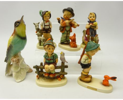 Five Goebel Hummel figurines including; 'Feeding Time', 'Puppy Love', 'Wayside Harmony' and two others and a Goebel bird, H20