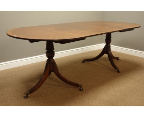 Early to mid 20th century Regency style mahogany and mahogany banded twin pedestal dining table, reeded out splayed legs with