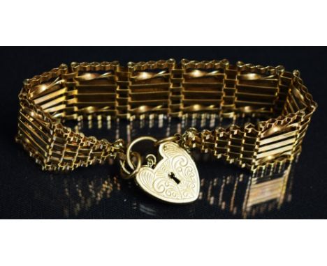 A 9ct gold gate bracelet, heart shaped locket, 25.7g