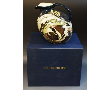An interesting and scarce contemporary Moorcroft Brown Badger pattern compressed ovoid jug, applied with a snowy winter lands