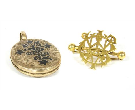 A front and back memorial locket, with floral and foliate pattern and black enamel cross with ribbon motif 'in memory of', wi