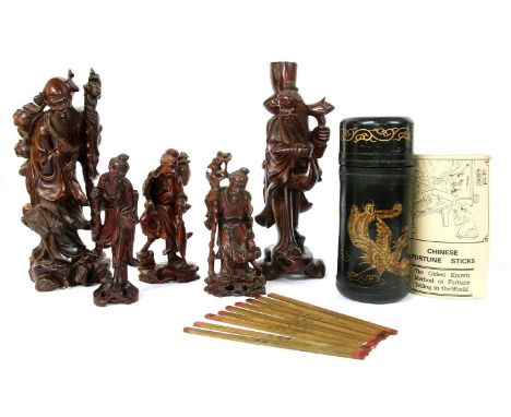 A collection of five Chinese wood figures, c.1900, of fishermen and shoulao, and a Chinese fortune stick, in a cylindrical bo