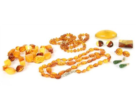 A collection of amber jewellery, to include a single graduated row butterscotch and yellow twisted tonneau shaped amber beads