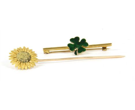 A stick pin with sunflower finial, and a bar brooch with central applied four leaf clover motif, with green guilloche enamel,