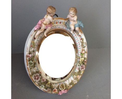 Small oval mirror encrusted with cherubs &amp; flowers (damaged) 