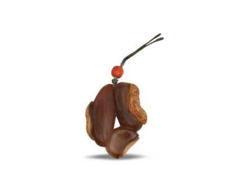 λ A CHINESE AGATE CARVING OF A GROUP OF NUTSQing dyansty, 19th centuryCarved as a date, a peanut and a chestnut in a syrup-co