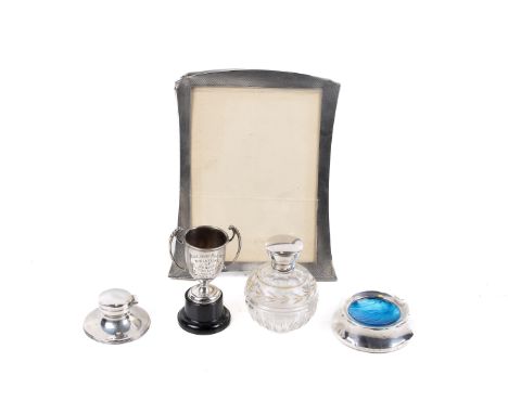 A small collection of silver and silver mounted items. Comprising a photograph frame, an inkwell, a small trophy, an ash tray