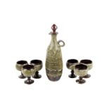 Glynn Hugo studio art pottery decanter and six matching goblets. Stamped 'Hugo' to the base. Max.
