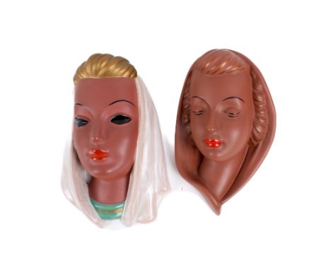 Two mid-century Goldscheider West German ceramic wall masks. Modelled as women with head scarves. Max. H23cm