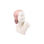 An Art Deco ceramic bust of a young woman.