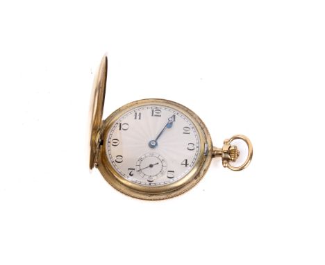 A hunter gold-filled cased pocket watch. With black Arabic numerals to the machine turned champagne face, stopwatch subsidiar