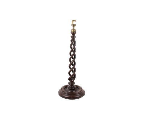 A mahogany triple barley twist lamp base candlestick. With brass finial and circular turned base. H50cm