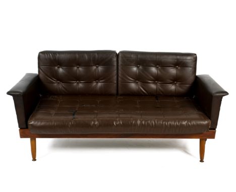A mid-century leatherette sofa fold out bed. Raised on turned tapering supports, drop down ends and removeable backrest. H74c
