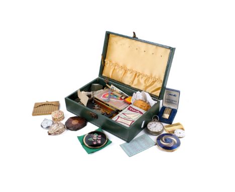 A green box full of collectables. Including a handbag shaped cigarette case, lighters, an early 20th century large stopwatch,