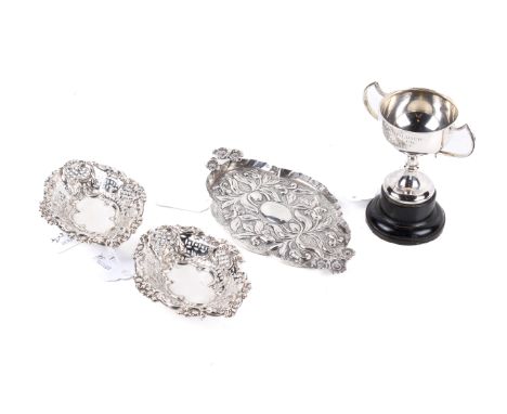 Four silver table items. Comprising a pair of pierced baskets, a Victorian repousse tray with handles in the form of three bl