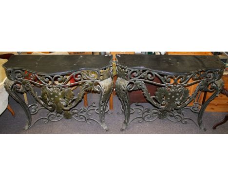 Pair of French metalwork console tables. With decorative scroll and applied decoration and moulded wooden tops. H92cm x W126c