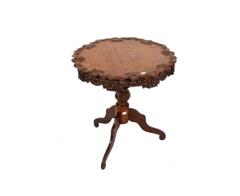 A Victorian oak carved tripod table. Having scroll carved edge above a frieze of acorns and oak leaves, turned and carved ped
