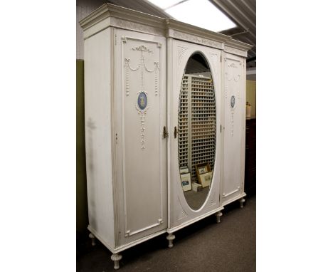 A large painted triple wardrobe. Centre section with oval mirror, either side opening for hanging space. Wedgewood style plaq