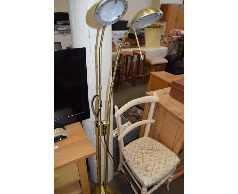 An adjustable twin light brass standard lamp