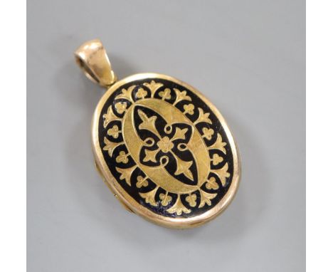 A Victorian engraved yellow metal and black enamel oval mourning locket, 3cm, gross 9.9 grams.CONDITION: Some chips and scrat