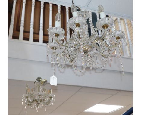 A modern cut glass and brass six-light chandelier and a similar chandelier