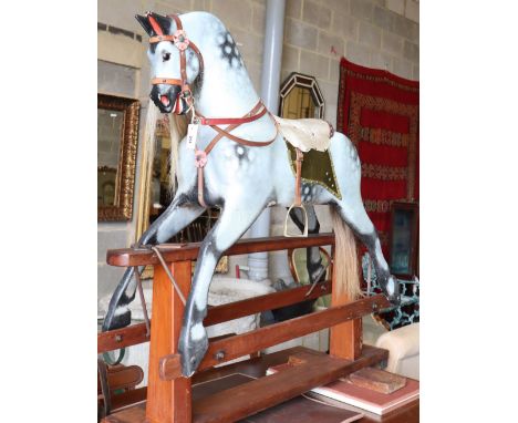A mid 20th century Collinson dapple grey rocking horse on pine safety frame (restored by Stevenson during the 1980's) W.145cm