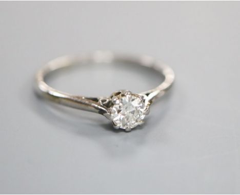 A white metal and solitaire diamond ring, size J/K, gross 2 grams, stone weighing approximately 0.15ct.