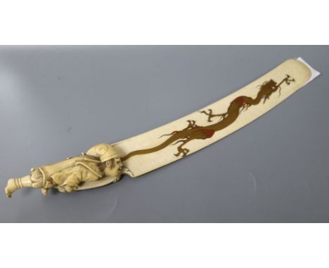 A carved ivory letter opener, with hand painted enamel gilt dragon, length 34cm