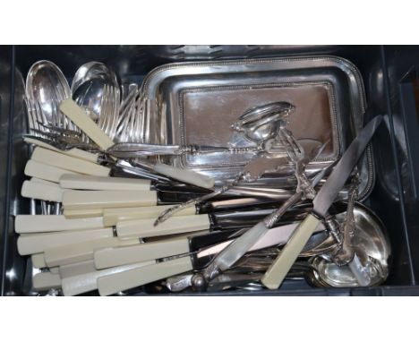 Assorted plated flatware, plated entree dish and soup ladle.
