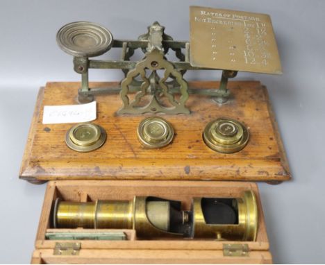 A set of letter scales and a miniature boxed microscope