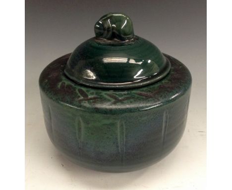 A Royal Doulton Chang type ribbed cylindrical tobacco jar, glazed throughout in dark jade green, the domed cover with rabbit 