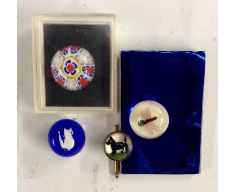 A glass paperweight millefiori button by John Gooderham, boxed;  another, with an encased glass dragonfly;  a blue glass pape
