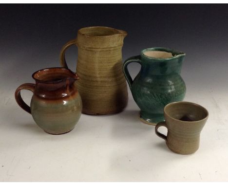 A Janet Leach brown glazed pottery mug, flared rim, impressed potter mark, 8.5cm high;  a David Leach glazed green pottery ju