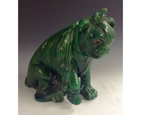 A Bretby model, After the Battle, an injured bulldog, he sits with wearing an eye patch and lifting his paw, green glaze, sgr