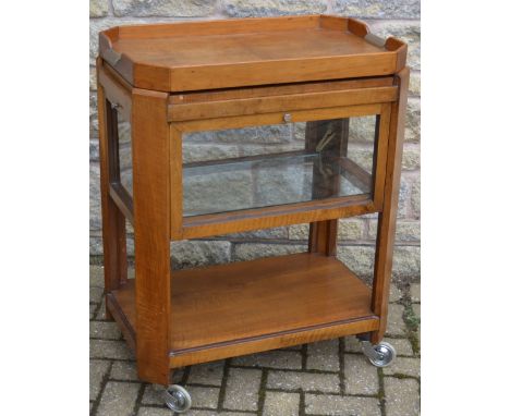 An Art Deco walnut canted rectangular two-tier tea trolley, the top with removable tray, chrome handles, four-hinged glazed s