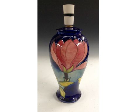 A Moorcroft Magnolia pattern baluster lamp base, tube lined with large pink flowerheads on a cobalt blue ground, 27cm high, i